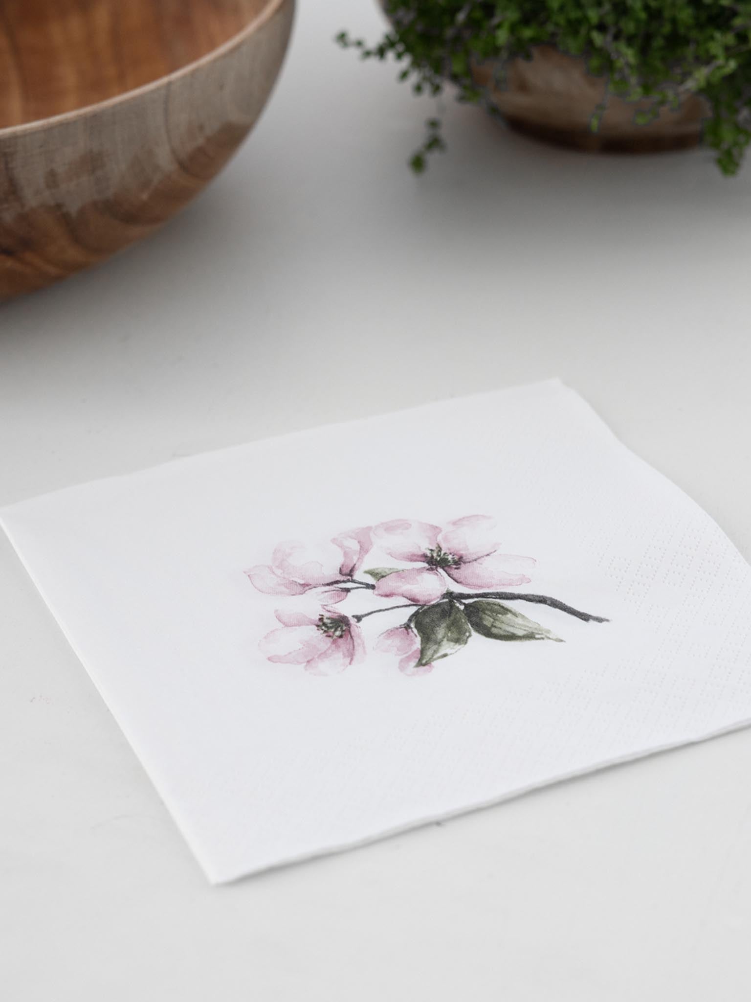 Serviett med epleblomst-motiv: hvit bunn, rosa blomster