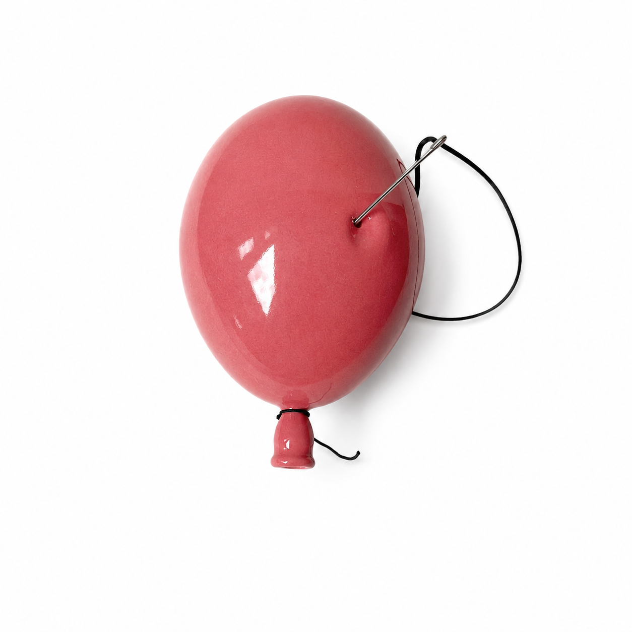Rosa latexballong med snor og svart holder, liten ventil i enden